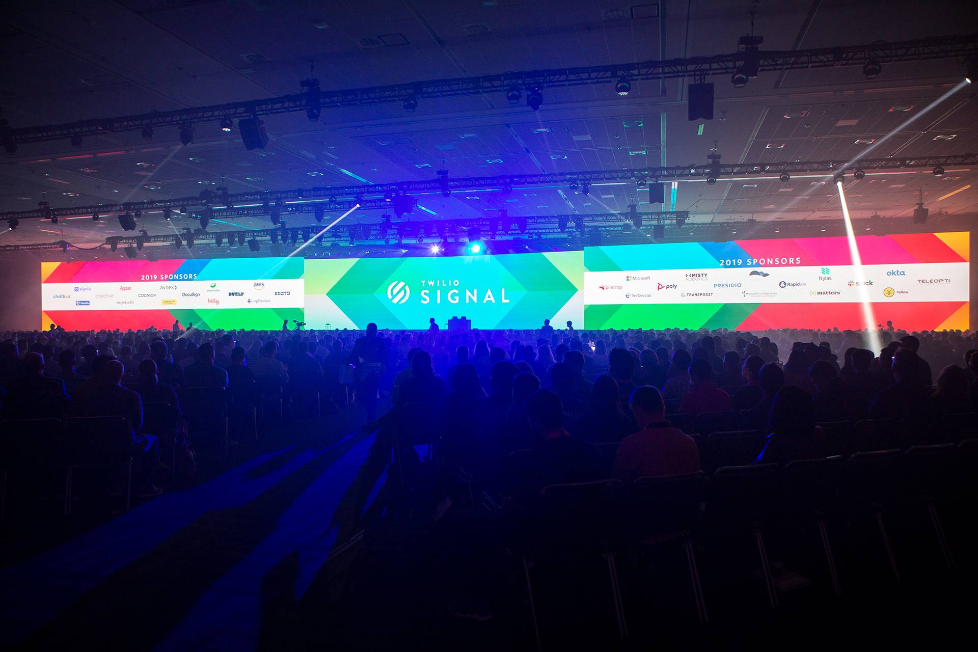 Twilio Signal 2019 opening with crowd silhouettes against colorful LED stage